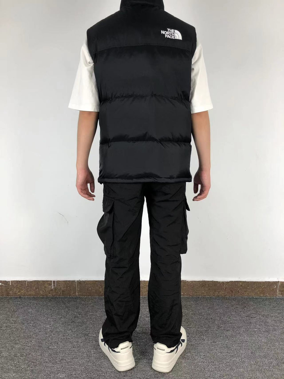 Black puffer gilet worn, back