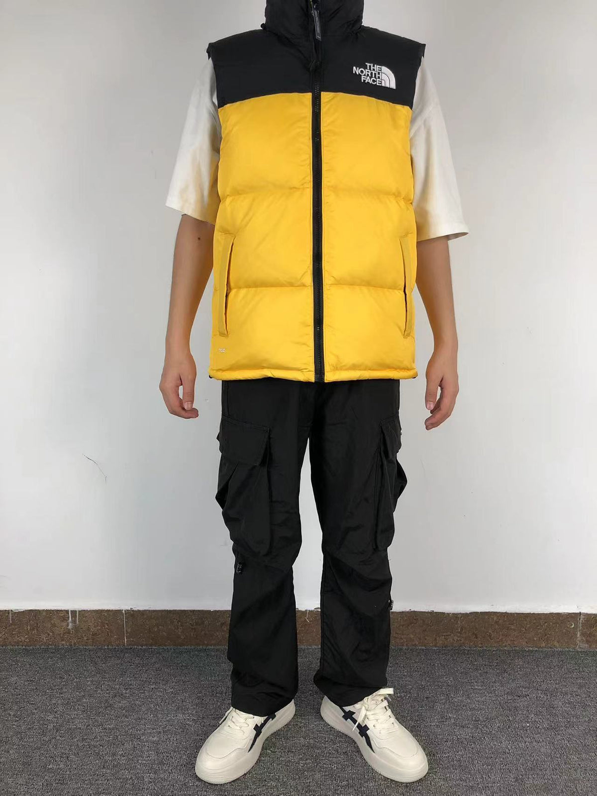 Yellow puffer gilet worn, front