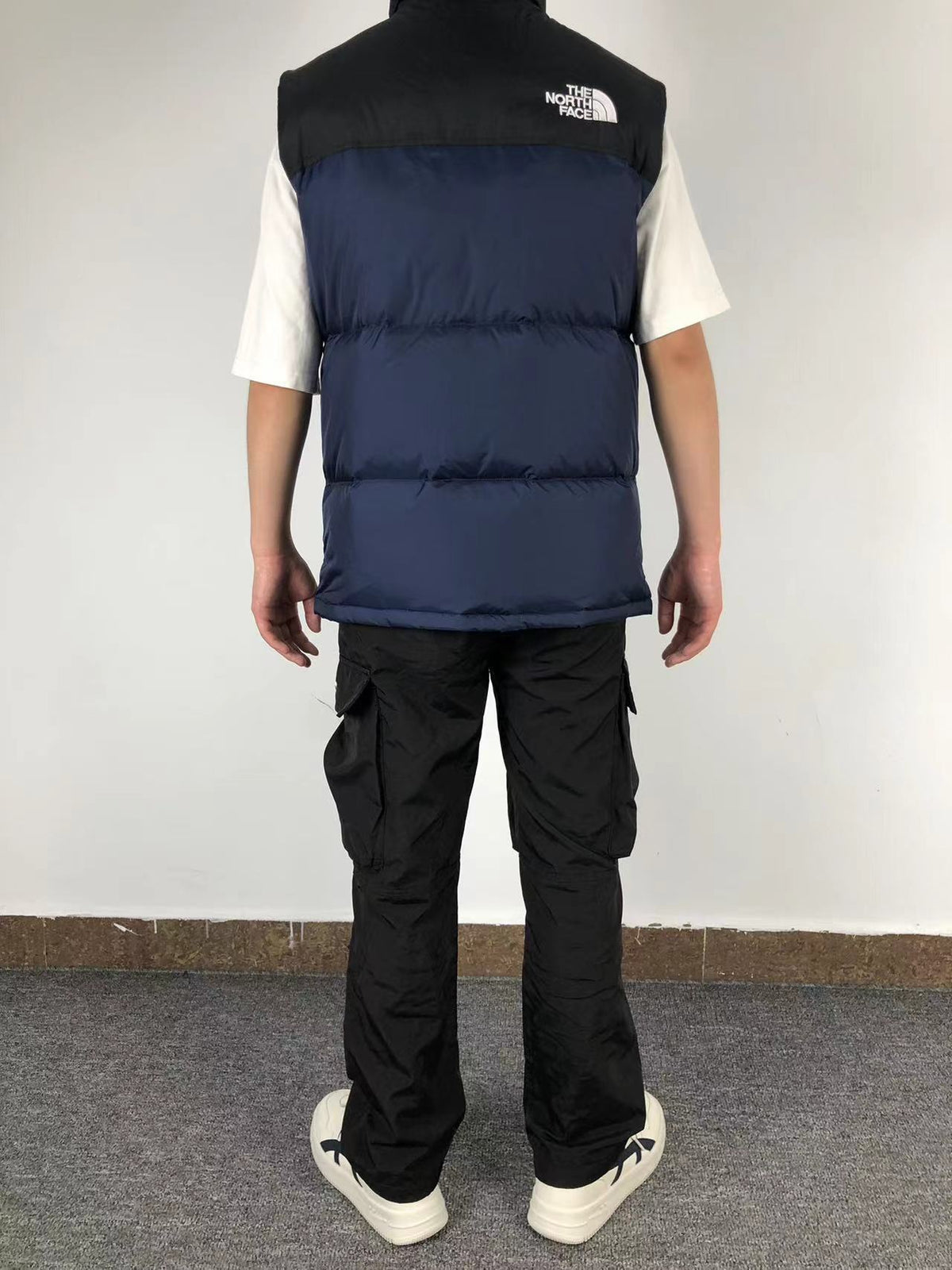 Navy puffer gilet worn, back