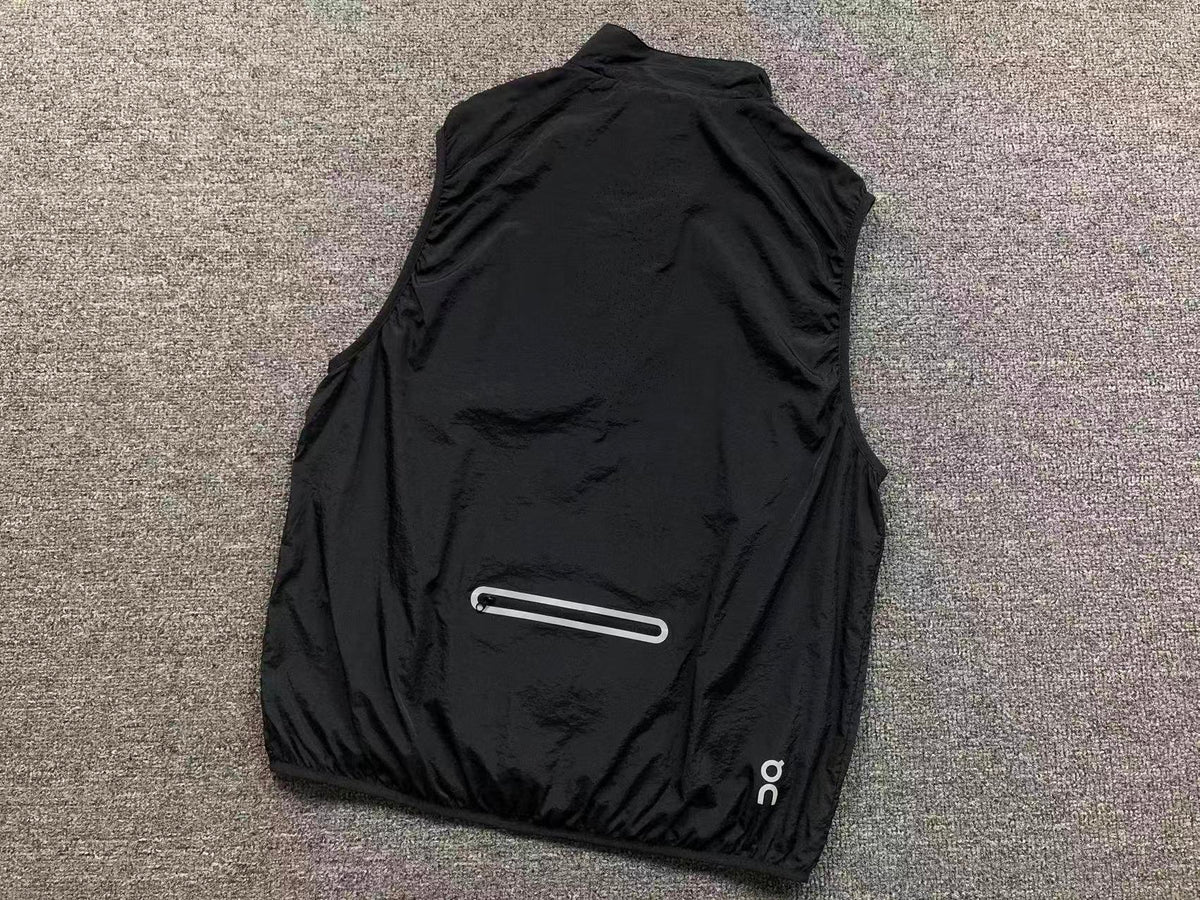 Black running gilet, back with reflective zip pocket
