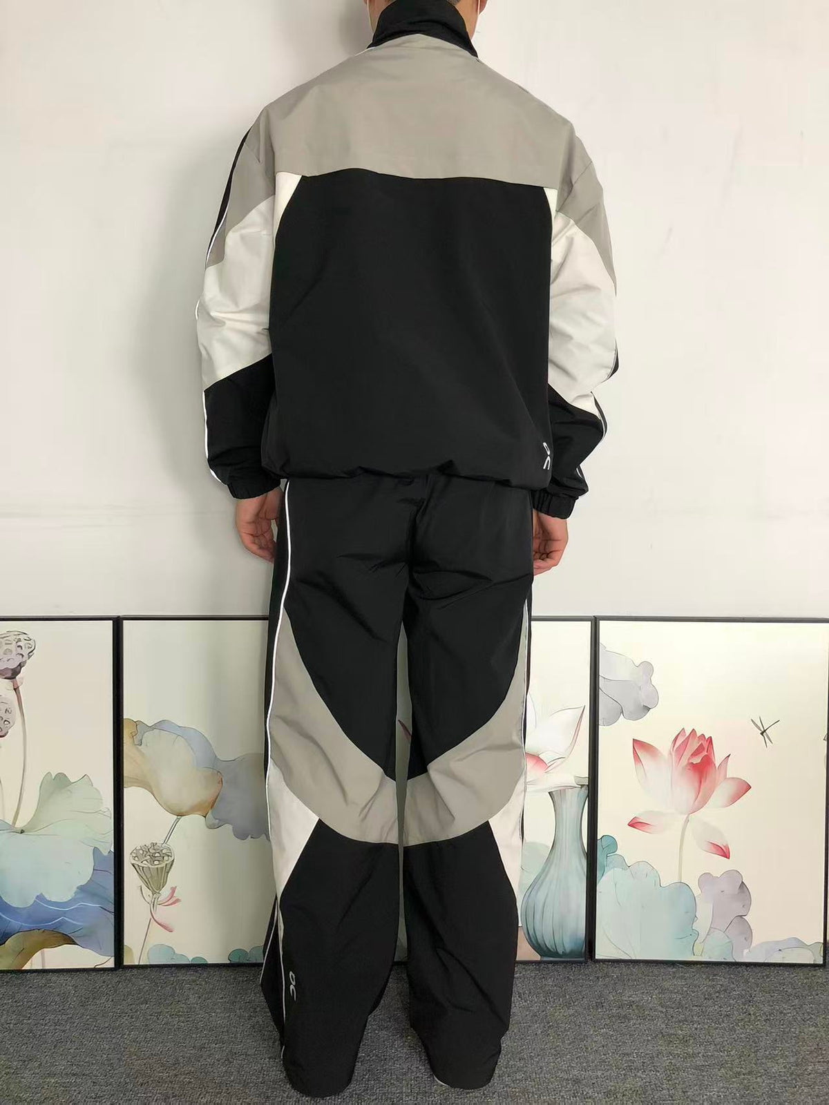 Black colour block tracksuit worn, back view