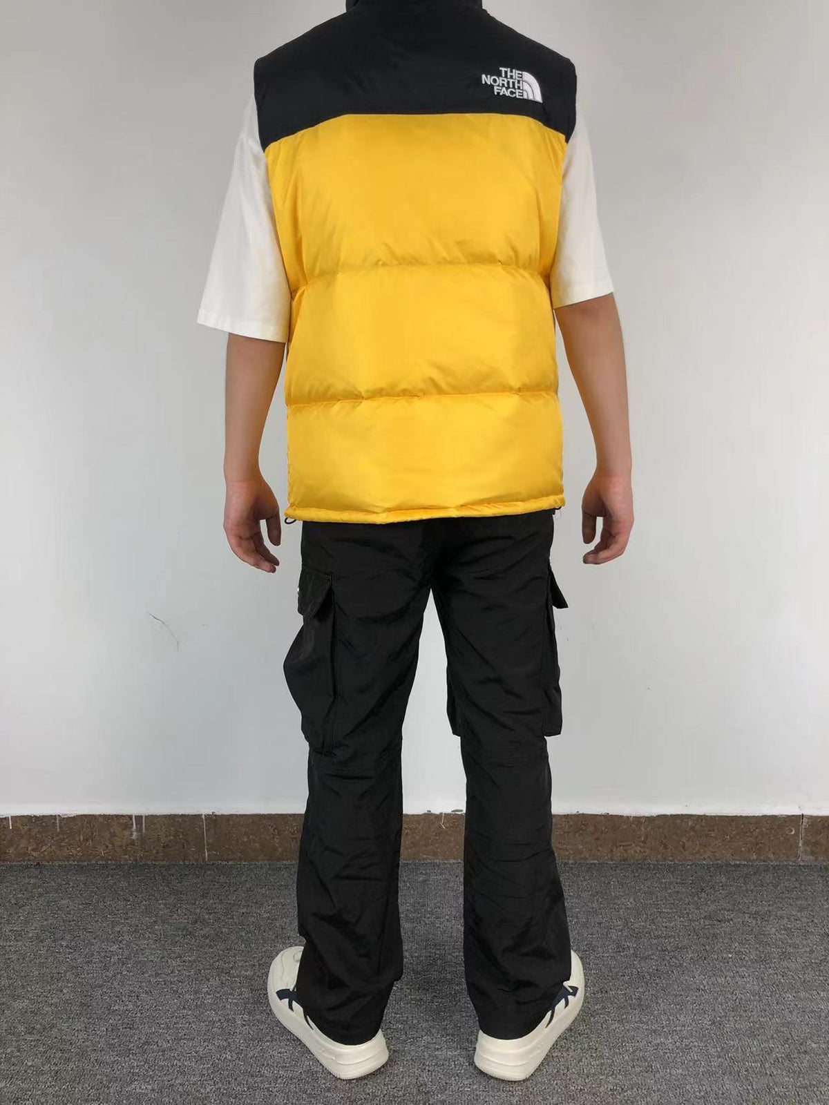Yellow puffer gilet worn, back