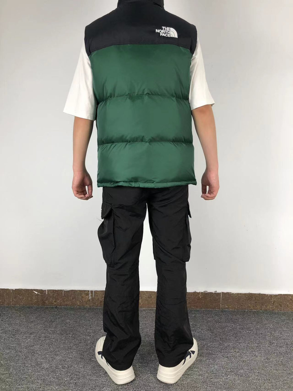 Green puffer gilet worn, back
