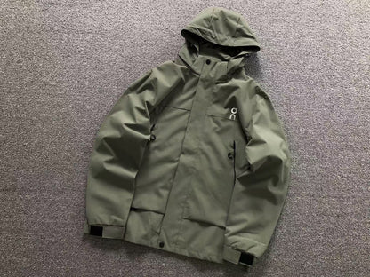 Army green hooded shell jacket with zip chest pockets and velcro cuffs