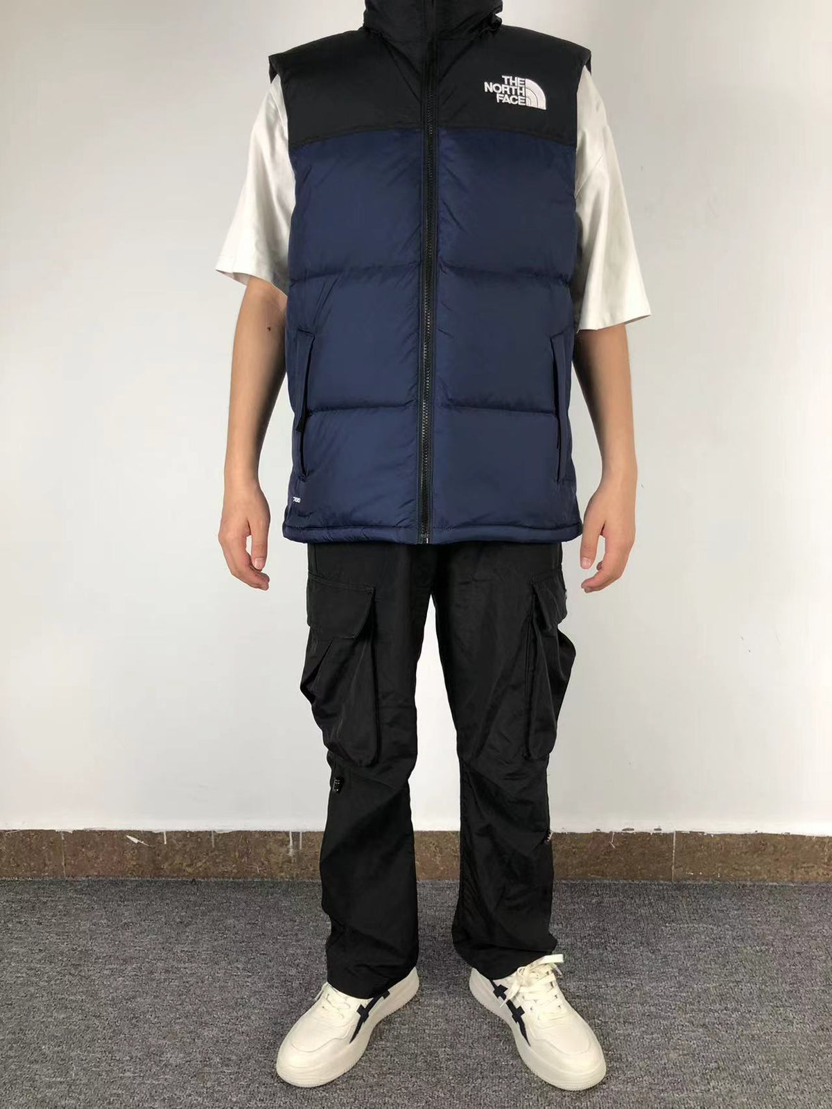 Navy puffer gilet worn, front