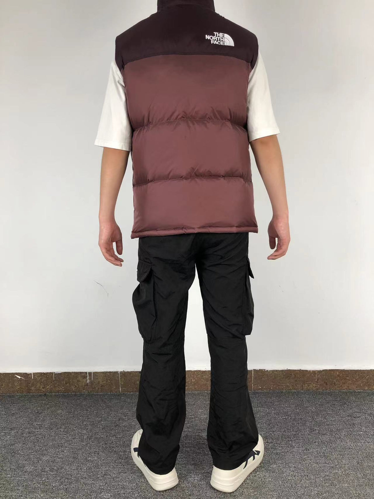 Burgundy puffer gilet worn, back