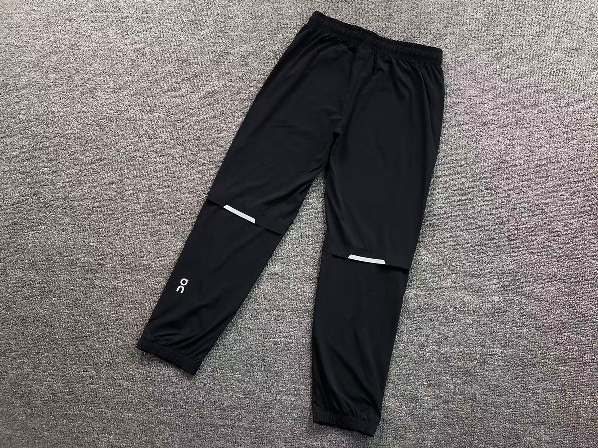 Black track pants, back with reflective knee strips